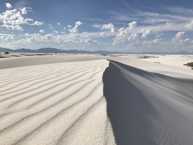 A gypsum dune ridge at White Sands under a cloud-streaked sky